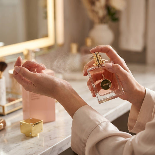 Woman applying Armaf Club de Nuit Woman Eau de Parfum spray to wrist