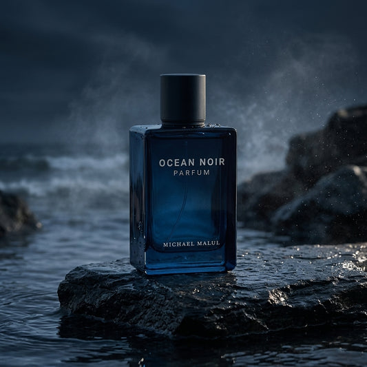 Michael Malul Ocean Noir Parfum bottle on wet dark slate rock with ocean spray mist