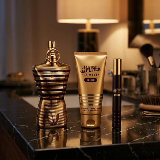 Jean Paul Gaultier Le Male Elixir set arranged on luxury dark marble vanity