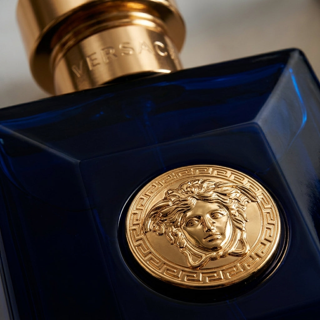 Macro detail of gold Medusa emblem on Versace Dylan Blue bottle