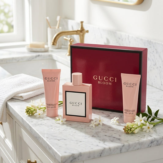 Gucci Bloom Eau de Parfum and body care set on marble vanity with white blossoms